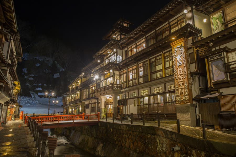 Lantern-lit ryokan street in Kurokawa Onsen, Kumamoto, at night
